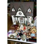 A WOODEN TWO STOREY DOLLS HOUSE, has slight damage, rear opening, fitted with electric lights (not