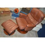 AN AVANTGLIDE BROWN LEATHER GLIDING RECLINING ARMCHAIR with a matching stool (2)