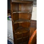 A DARK ERCOL OPEN CORNER CUPBOARD with a single cupboard door, together with a painted Ducal pine