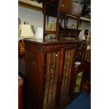 AN EARLY 20TH CENTURY CARVED LEAD GLAZED TWO DOOR BOOKCASE, width 96cm x depth 49cm x height 151cm