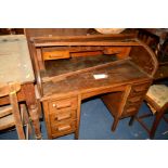 AN EARLY TO MID 20TH CENTURY OAK ROLL TOP DESK with six drawers, width 107cm x depth 69cm x height