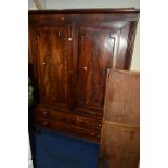 A GEORGIAN MAHOGANY PANELLED TWO DOOR LINEN PRESS with a single linen slide above two long drawers