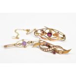 THREE EARLY 20TH CENTURY GOLD GEM BROOCHES, the first an elongated brooch set with a central