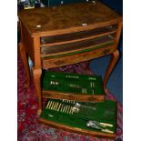 AN EARLY 20TH CENTURY WALNUT THREE TABLE CANTEEN OF CUTLERY, on four cabriole legs with pad feet,