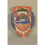 A 19TH CENTURY PAINTED CARTOUCHE SHAPED WOODEN PLAQUE, the centre painted with a white bull, bears