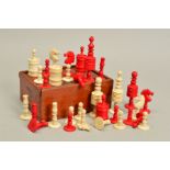 A SET OF 19TH CENTURY CARVED BONE CHESS PIECES, red stained and natural, tallest pieces 10.5cm and