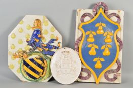 A 19TH CENTURY LARGE FAIENCE ARMORIAL WALL PLAQUE, of shaped octagonal form, decorated in relief,
