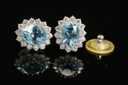 A PAIR OF MODERN OVAL AQUAMARINE AND DIAMOND CLUSTER EARRINGS, post fittings, measuring