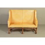 A LATE 19TH CENTURY CREAM LEATHER UPHOLSTERED SETTLE, on block and baluster turned stretchers, width