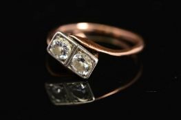 A MID 20TH CENTURY TWO STONE DIAMOND RING, each diamond grain set within a box setting, cross over
