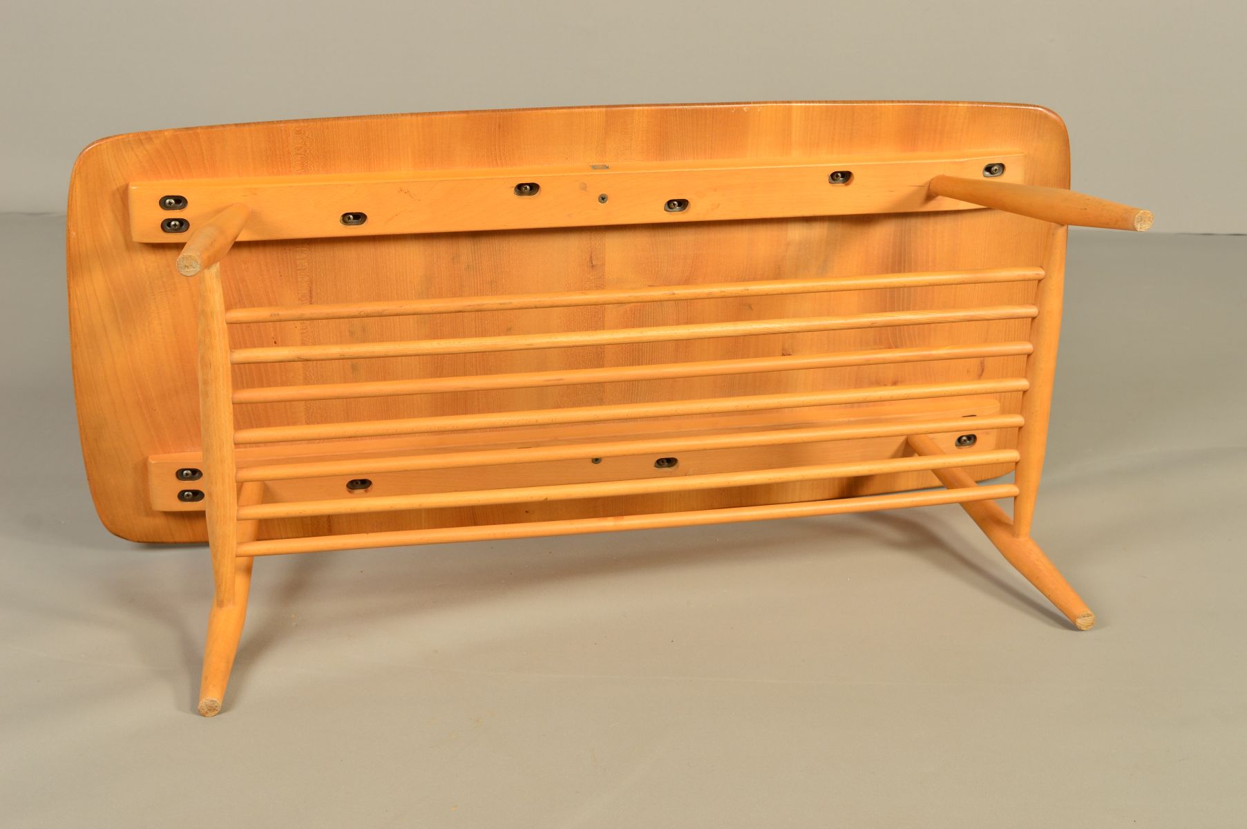 AN ERCOL BLONDE ELM RECTANGULAR COFFEE TABLE, on four beech tapering legs united by a spindled - Image 5 of 6