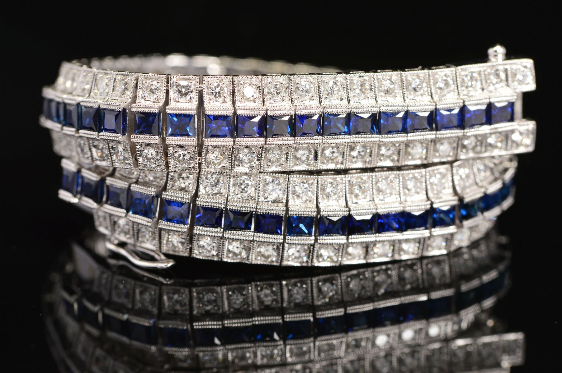 A MODERN SAPPHIRE AND DIAMOND LINE BRACELET, centring on a line of calibre square cut blue - Image 5 of 5