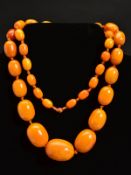 A NATURAL AMBER NECKLACE, designed as thirty-nine graduated beads measuring approximately 13mm to