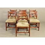 A SET OF SEVEN GEORGE III MAHOGANY DINING CHAIRS, the scrolled back with a rectangular bar and