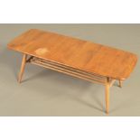 AN ERCOL BLONDE ELM RECTANGULAR COFFEE TABLE, on four beech tapering legs united by a spindled