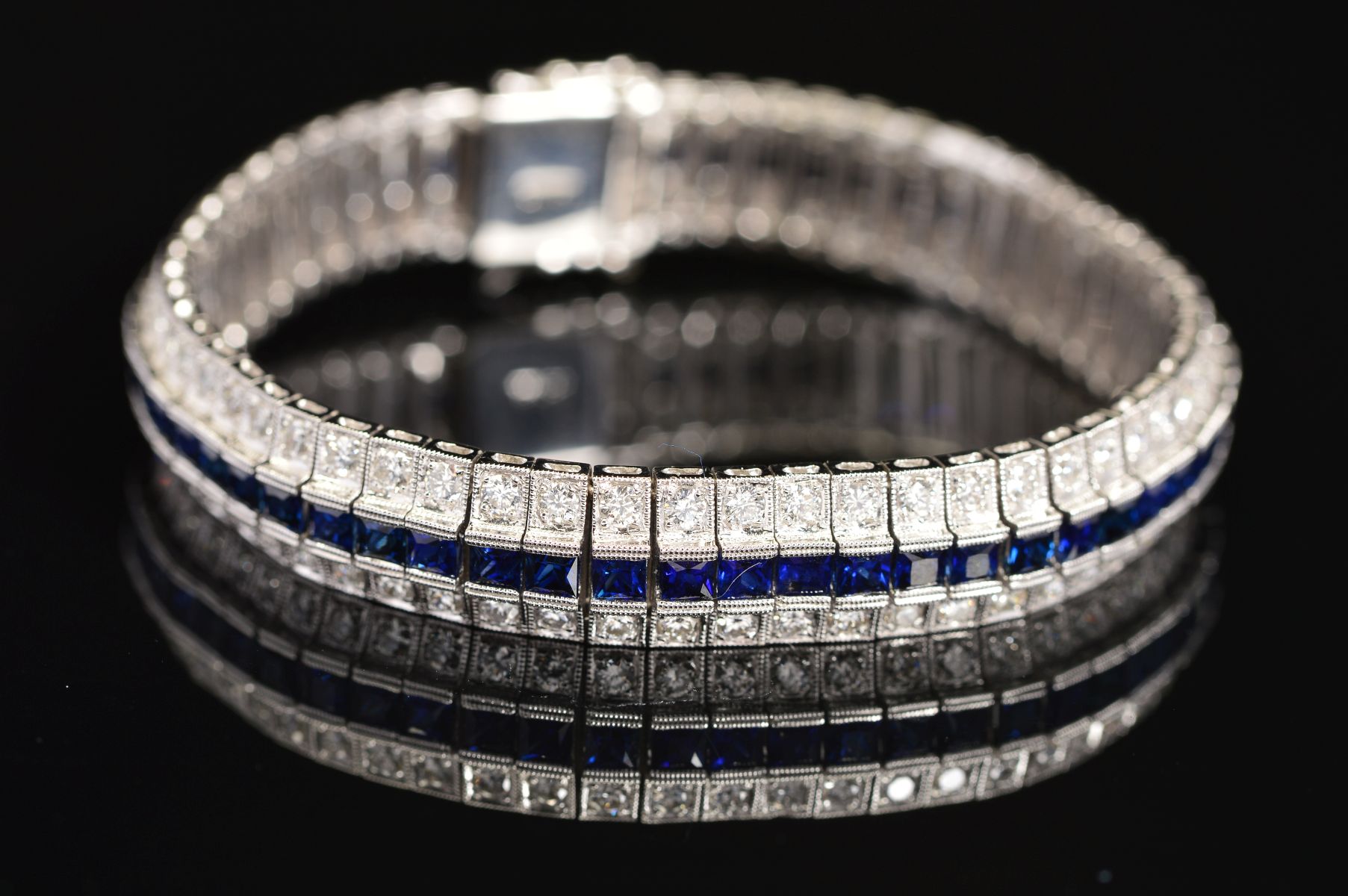 A MODERN SAPPHIRE AND DIAMOND LINE BRACELET, centring on a line of calibre square cut blue - Image 2 of 5