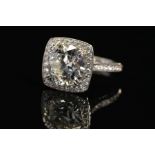 A STUNNING MODERN LARGE DIAMOND RING, centring on a transitional round brilliant cut diamond,