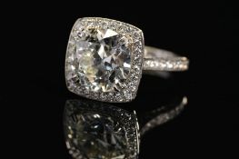A STUNNING MODERN LARGE DIAMOND RING, centring on a transitional round brilliant cut diamond,