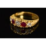 A LATE 20TH CENTURY 18CT RUBY AND DIAMOND CARVED HALF HOOP FIVE STONE RING, scroll carved