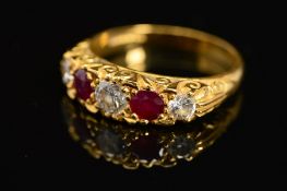 A LATE 20TH CENTURY 18CT RUBY AND DIAMOND CARVED HALF HOOP FIVE STONE RING, scroll carved