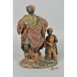 A 19TH CENTURY COLD PAINTED TERRACOTTA FIGURE GROUP OF TWO BLACKAMOORS, modelled as an adult male