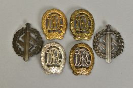 FOUR GERMAN 3RD REICH 'D.R.L' SPORT BADGES, three appear to be the bronze award with the other being