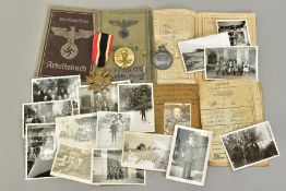 A GROUP OF 3RD REICH WWII MEDALS AND BADGES, plus paperwork relating to two members of the same