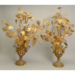 A PAIR OF LATE 19TH/EARLY 20TH CENTURY GILT METAL DECORATIVE URNS, both mounted with arrangements of
