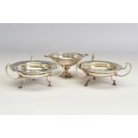 A PAIR OF GEORGE V SILVER BON BON DISHES, of circular form, with three open scrolled handles and