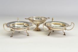 A PAIR OF GEORGE V SILVER BON BON DISHES, of circular form, with three open scrolled handles and