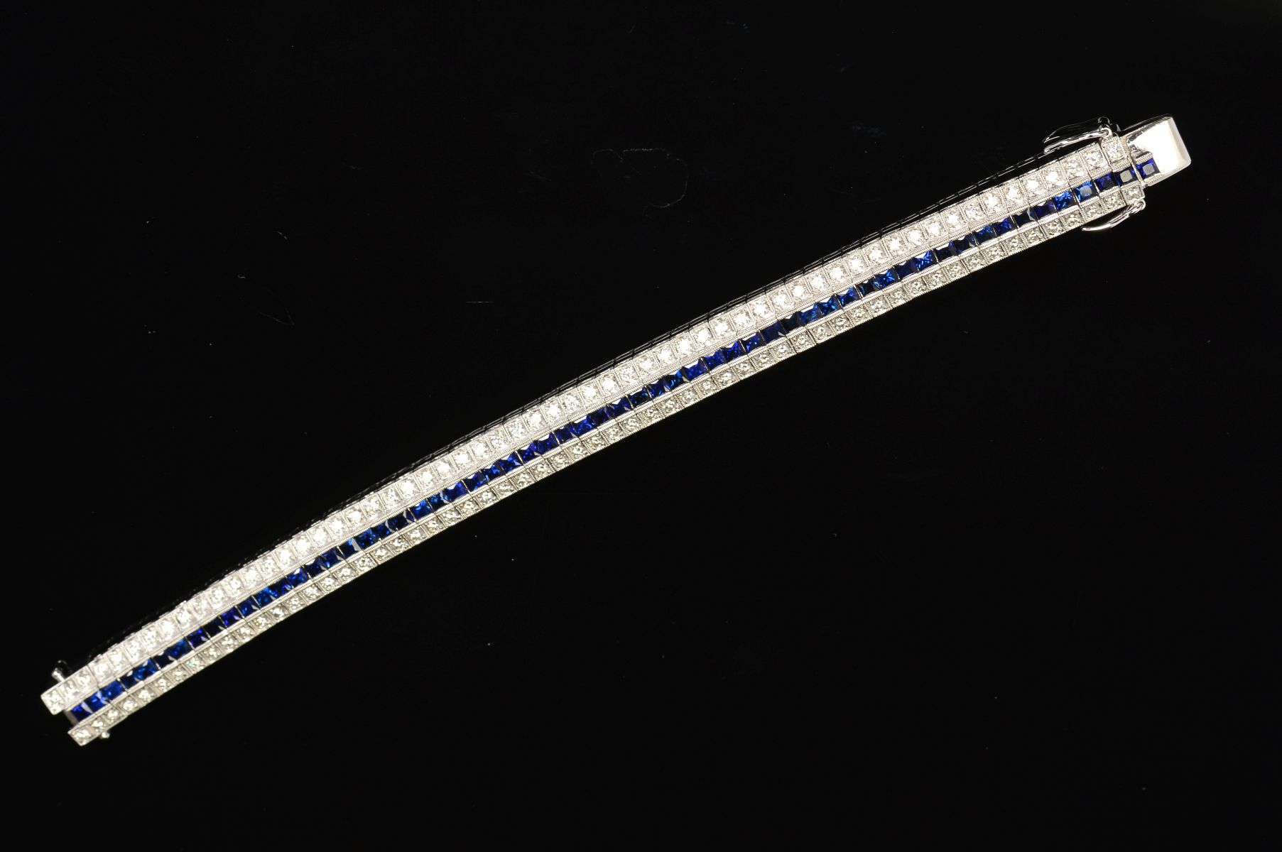 A MODERN SAPPHIRE AND DIAMOND LINE BRACELET, centring on a line of calibre square cut blue - Image 4 of 5