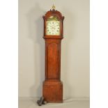 A GEORGE III OAK LONGCASE CLOCK, the arched hood with damaged ball finial with fret carved
