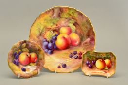 A ROYAL WORCESTER FRUIT STUDY CABINET PLATE, painted with apples, purple grapes and blackberries