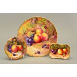 A ROYAL WORCESTER FRUIT STUDY CABINET PLATE, painted with apples, purple grapes and blackberries