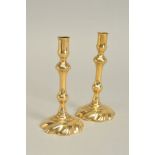 A PAIR OF MID 18TH CENTURY BRASS TAPER STICKS, knopped stem with a domed swirl base, circa 1755,
