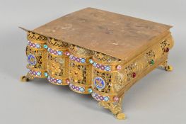 A 20TH CENTURY GILT METAL FOOTSTOOL, of rectangular form, the hinged top with engraved decoration