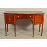 A GEORGE IV MAHOGANY AND EBONY STRONG BOW FRONT SIDEBOARD, fitted with a central frieze drawer