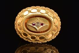 A LATE VICTORIAN GOLD, DIAMOND AND RUBY MEMORIAL BROOCH, of oval outline, the central old cut