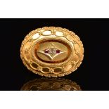 A LATE VICTORIAN GOLD, DIAMOND AND RUBY MEMORIAL BROOCH, of oval outline, the central old cut