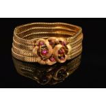 A CONTINENTAL FOUR ROW SNAKE BRACELET, fitted to large feature scroll design clasp set with