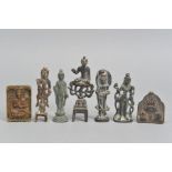 A GROUP OF FOUR SMALL BRONZE STANDING FIGURES OF BUDDHA, all probably South East Asian, together