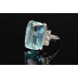 AN ART DECO AQUAMARINE AND DIAMOND RING, centring on a rectangular cut aquamarine measuring