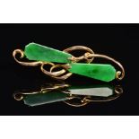 A JADE BROOCH, of horizontal organic design, set with two kite shape jade panels as abstract