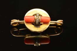AN ART DECO GOLD, CORAL AND DIAMOND BROOCH, designed as a central circular panel encasing a polished