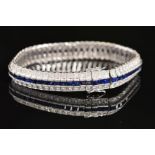 A MODERN SAPPHIRE AND DIAMOND LINE BRACELET, centring on a line of calibre square cut blue