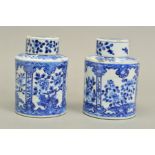 A NEAR PAIR OF 19TH CENTURY CHINESE PORCELAIN CYLINDRICAL CANISTERS AND COVERS, blue and white