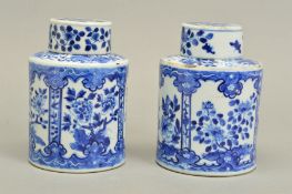 A NEAR PAIR OF 19TH CENTURY CHINESE PORCELAIN CYLINDRICAL CANISTERS AND COVERS, blue and white