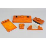 A GROUP OF FIVE ART DECO CARVACRAFT DESK ACCESSORIES IN BUTTERSCOTCH AMBER BAKELITE, comprising a