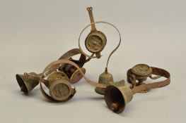 A GRADUATED SET OF EIGHT SERVANT'S BELLS, six with stamped metal rose decoration to the hanging