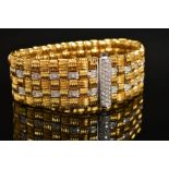A MODERN 18CT GOLD ROBERTO COIN DIAMOND BRACELET, a wide flat panel link textured pattern with